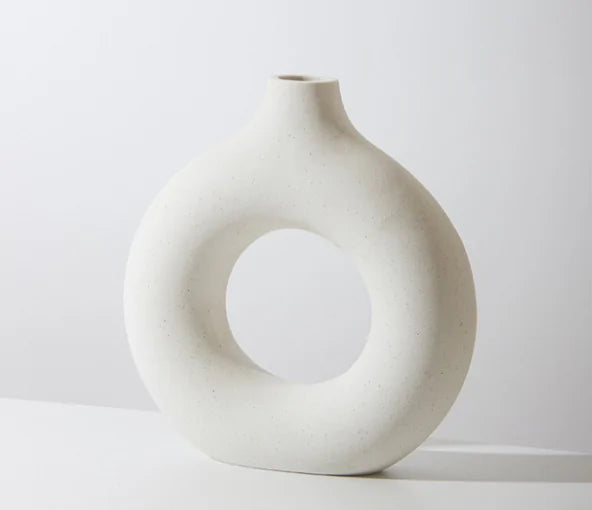 Ceramic donut flower vase on shelf  